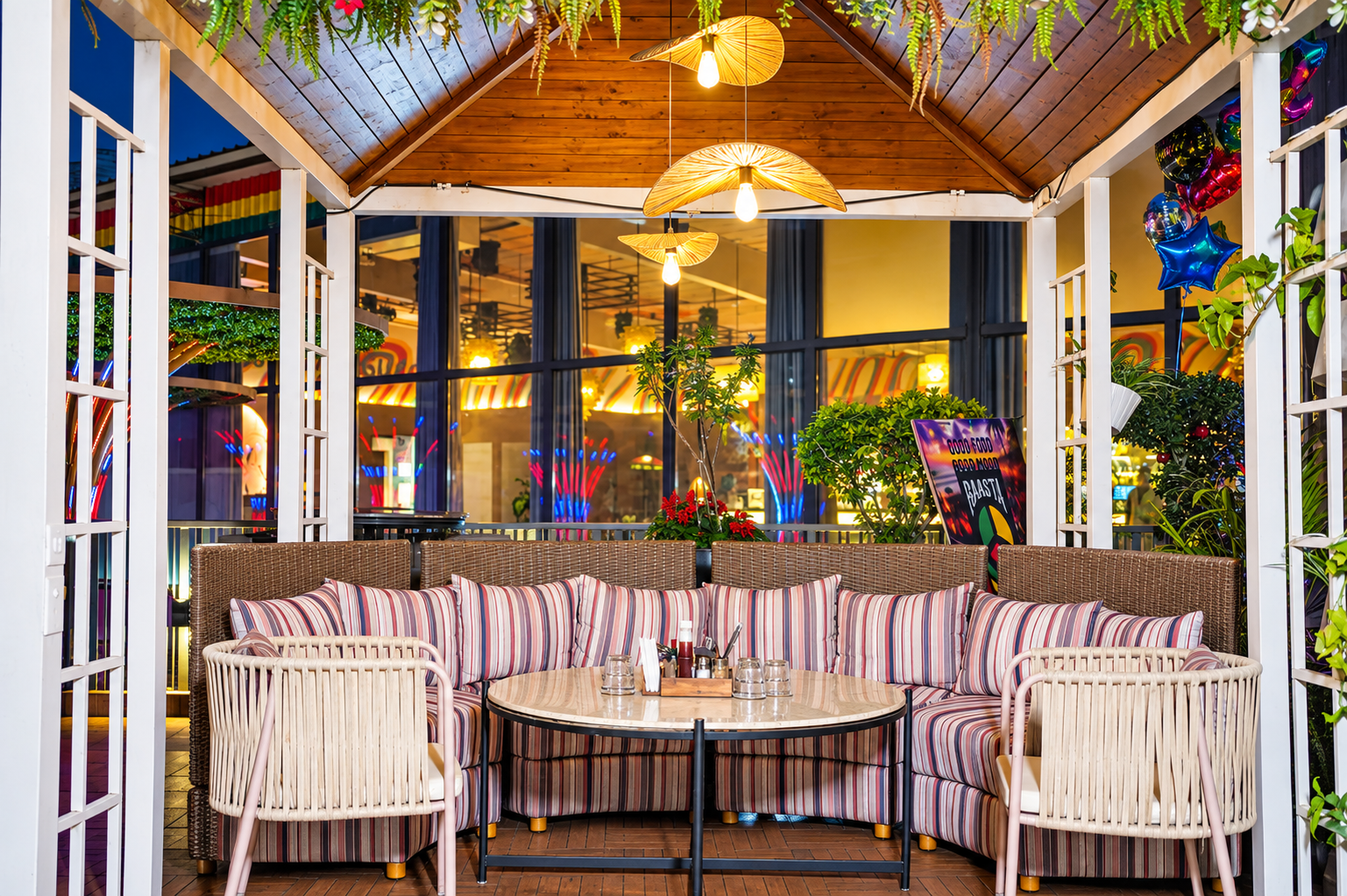 A restaurant interior lit by pendant lamps, banquette seating along a panelled wall.